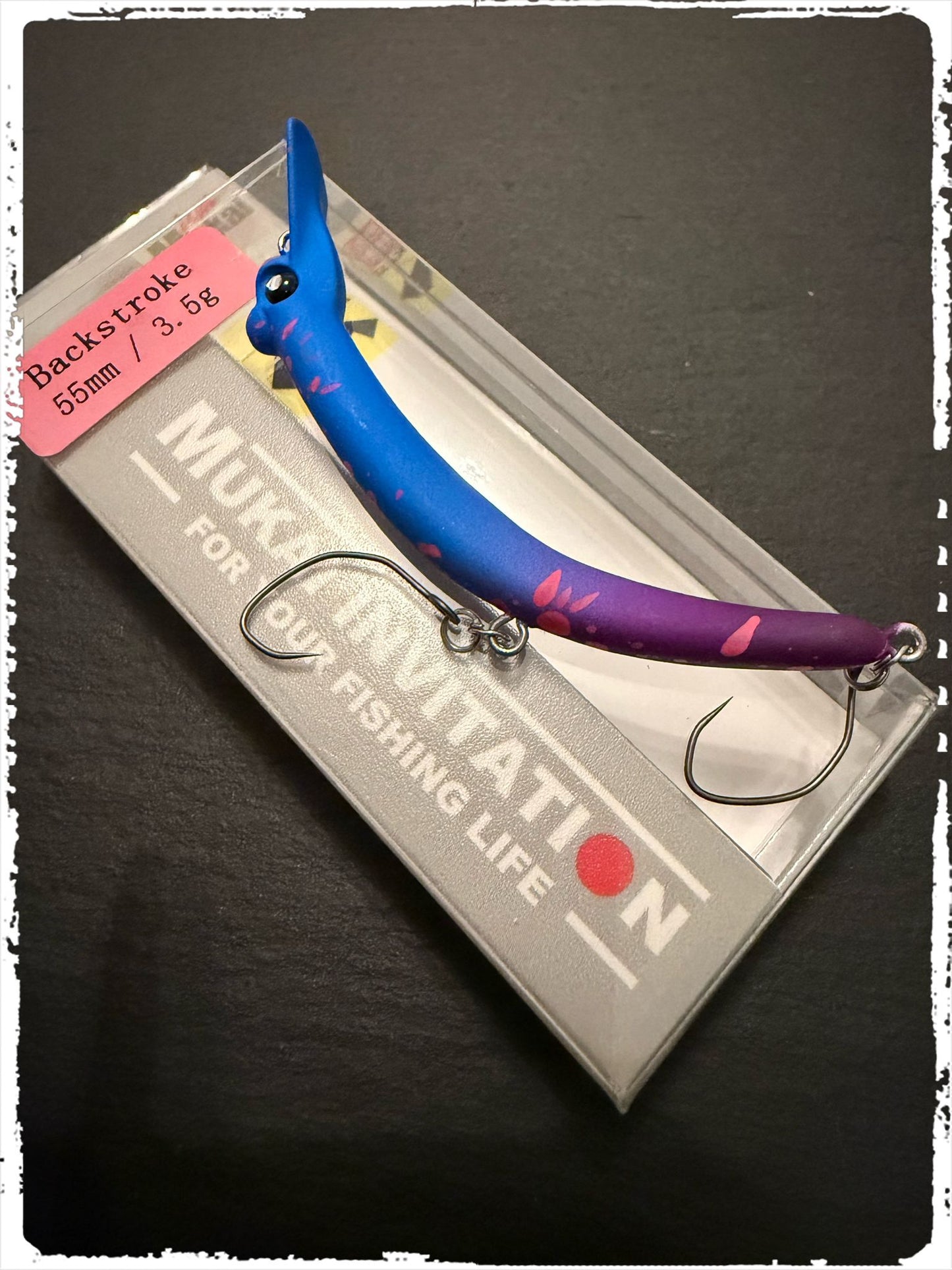 Mukai Backstroke 55 S wobbler in vibrant colors, showcasing its detailed design and lifelike features for fishing.